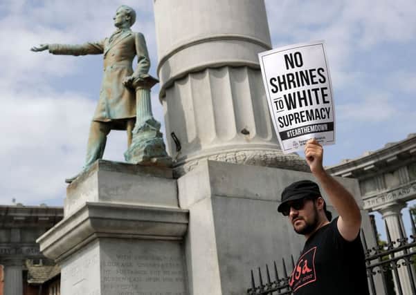 Protesters gather at the Jefferson Davis Monument August 19, 2018 in Richmond, Virginia. The protesters rallied in opposition to Confederate heritage groups that were protesting against the recommendation from Richmond Mayor Levar Stoney's Monument Avenue Commission to remove the statue.  PIC: Chip Somodevilla/Getty Images
