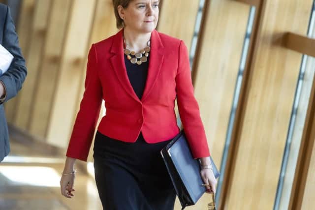 First Minister Nicola Sturgeon walks to First Minister's Questions