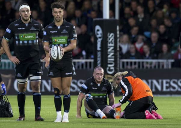 Stuart Hogg is treated on the pitch during Glasgow's win over Munster. Picture: SNS