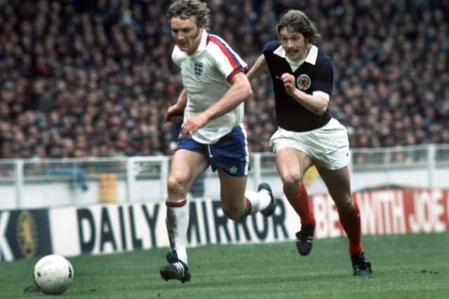 Kevin Beattie storms away from Arthur Duncan in England's 5-1 win over Scotland at Wembley in 1975. Picture: Colorsport/REX/Shutterstock