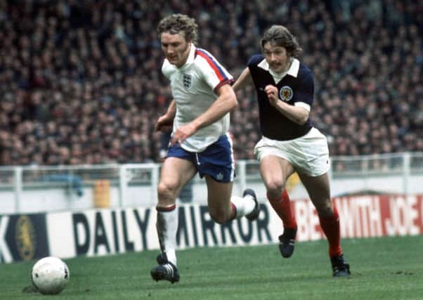 Kevin Beattie storms away from Arthur Duncan in England's 5-1 win over Scotland at Wembley in 1975. Picture: Colorsport/REX/Shutterstock
