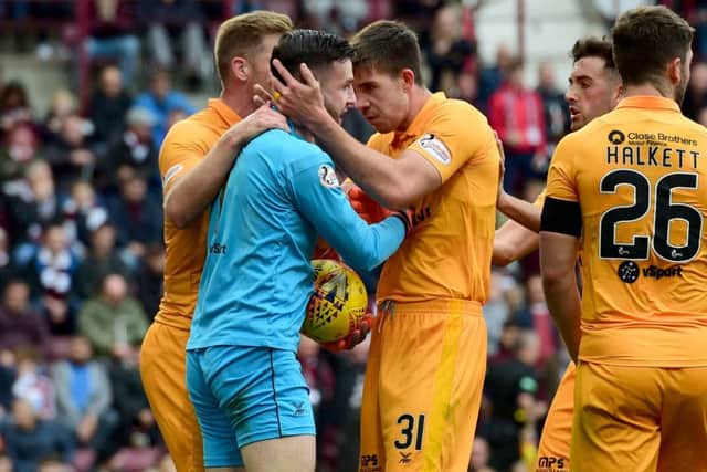 Kelly is hailed by his team mates after beating away Naismith's effort. Picture: SNS Group