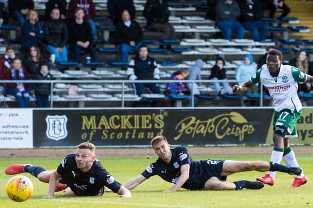 Thomas Agyepong bamboozles two Dundee defenders who can only watch as the Ghanaian makes it 3-0. Picture: SNS Group