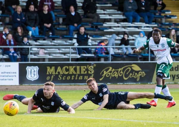 Thomas Agyepong bamboozles two Dundee defenders who can only watch as the Ghanaian makes it 3-0. Picture: SNS Group