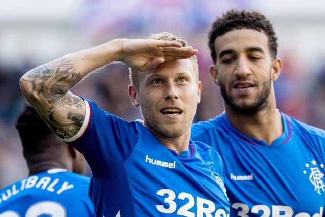 Scott Arfield celebrates after scoring in Rangers 5-1 rout of St Johnstone but Steven Gerrard, below, is not getting carried away. Picture: SNS