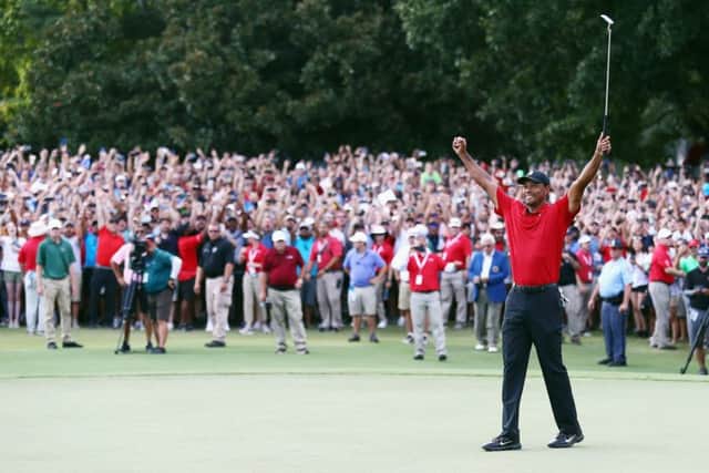 Tiger Woods celebrates making par on the 18th green to win the TOUR Championship at East Lake Golf Club. Picture: Getty Images