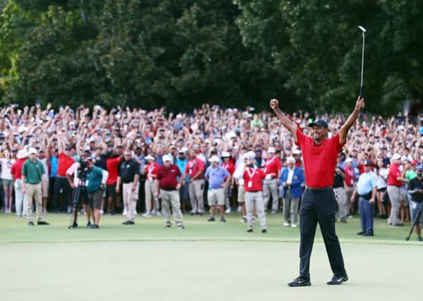 Tiger Woods celebrates making par on the 18th green to win the TOUR Championship at East Lake Golf Club. Picture: Getty Images