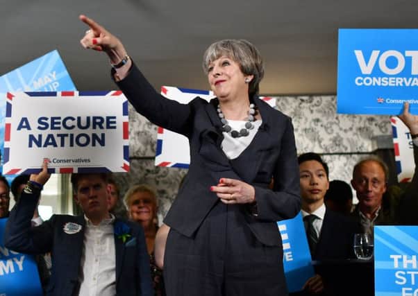 Theresa May delivers a speech during an election campaign visit to Langton Rugby Club in June last year