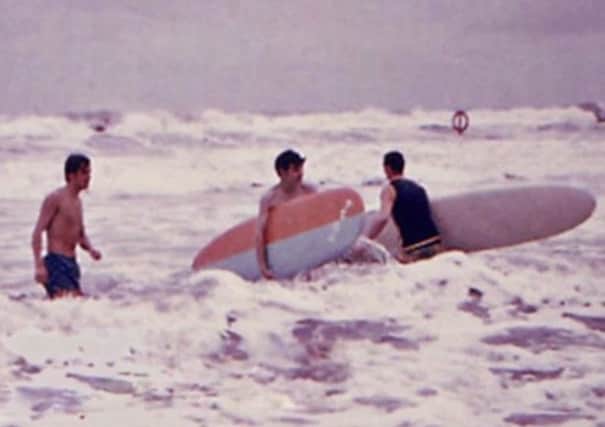 Stuart Crichton, Ian Wishart and George Law surfing at Aberdeen Beach, September 1968