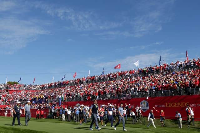 Rory McIlroy and Patrick Reed  walk off the first tee at the start of their epic clash at Hazeltine in 2016.