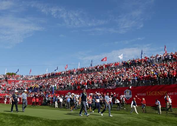 Rory McIlroy and Patrick Reed  walk off the first tee at the start of their epic clash at Hazeltine in 2016.