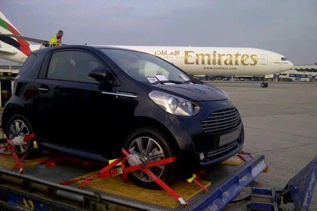 Cars outside an Emirates plane.