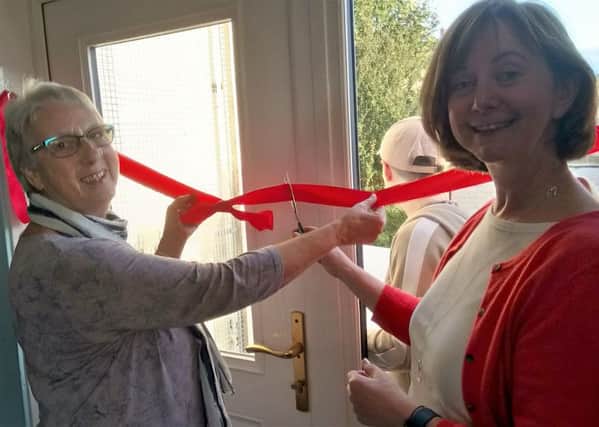 Morag MacDonald (right) from Melville Housing Association  and also Y2K Board Treasurer, cutting the ribbon to the open the refurbished Y2K in Mayfield. Also in the picture is Mabel Currie (glasses) Chair of Y2K Board.