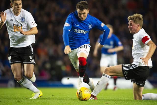 Rangers winger Glenn Middleton sees off the challenge of Ayr United's Andy Geggan during the Ibrox side's 4-0 Betfred Cup win. Picture: SNS