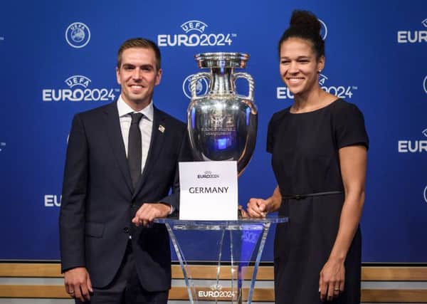 Head of the German bid Philipp Lahm, left, and former German international Celia Sasic pose with the Uefa trophy in Nyon. Picture: AFP/Getty Images