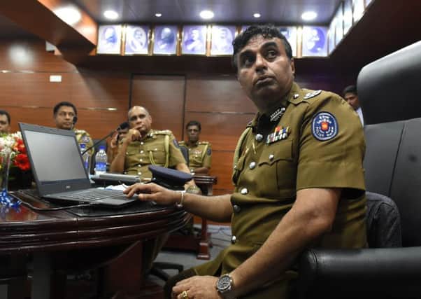 Sri Lanka police chief Pujith Jayasundara, right, at police headquarters in Colombo. Photograph: Ishara S Kodikara/Getty