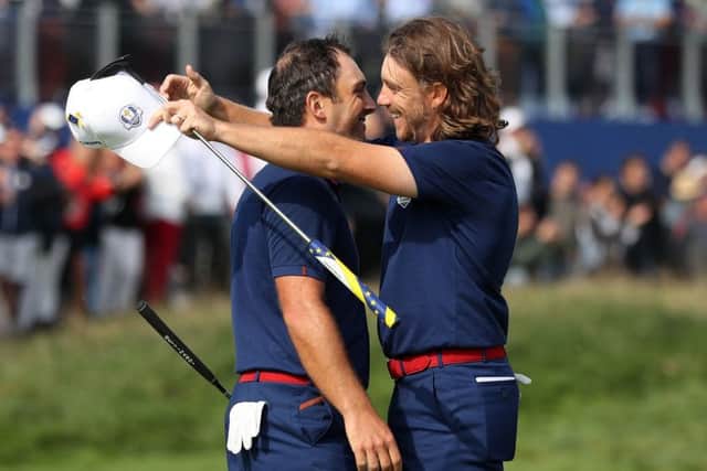Francesco Molinari and Tommy Fleetwood embrace after securing a vital point for Europe in the opening session at Le Golf National. Picture: PA