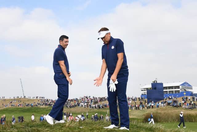 Ian Poulter, right, and Rory McIlroy in conversation during their foursomes match. Picture: Franck Fife/AFP/Getty Images