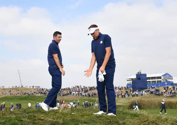 Ian Poulter, right, and Rory McIlroy in conversation during their foursomes match. Picture: Franck Fife/AFP/Getty Images