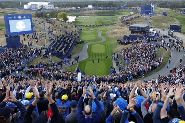 General view of the 1st hole as fans clap their hands on the opening day of the 2018 Ryder Cup at Le Golf National in Saint-Quentin-en-Yvelines, outside Paris, France, Friday, Sept. 28, 2018. (AP Photo/Laurent Cipriani)