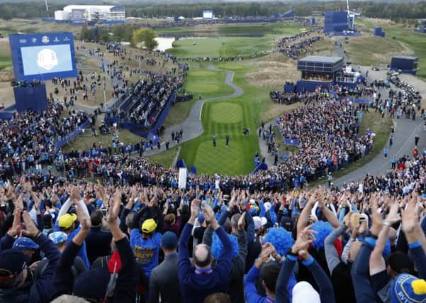 General view of the 1st hole as fans clap their hands on the opening day of the 2018 Ryder Cup at Le Golf National in Saint-Quentin-en-Yvelines, outside Paris, France, Friday, Sept. 28, 2018. (AP Photo/Laurent Cipriani)