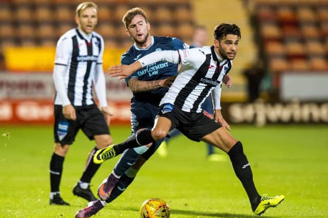 Dunfermlines Faissal El Bakhtaoui holds off the challenge of Partick Thistles Craig Slater. Picture: SNS.
