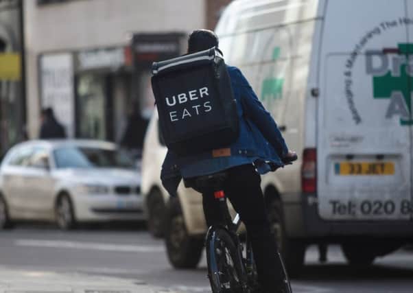 Uber Eats couriers are calling for a minimum drop fee of £5 a delivery. Photograph: Getty Images