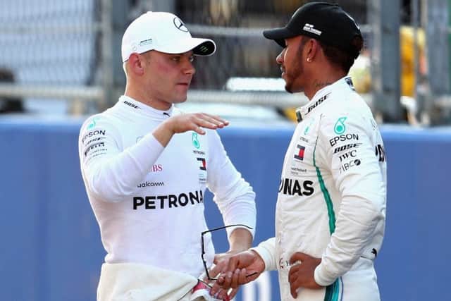 Valtteri Bottas talks with Lewis Hamilton during qualifying. Pic: Clive Rose/Getty