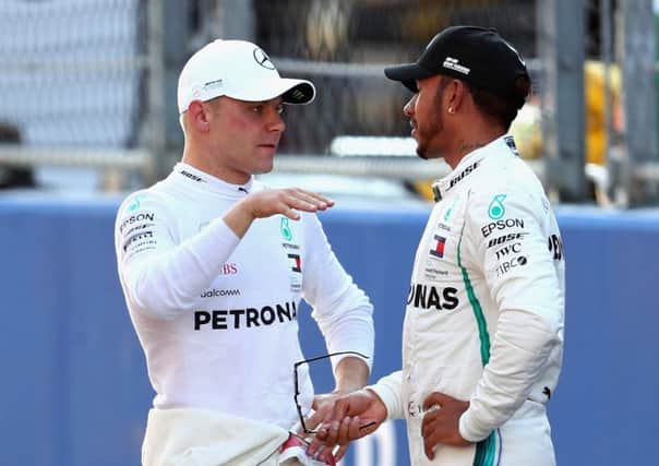 Valtteri Bottas talks with Lewis Hamilton during qualifying. Pic: Clive Rose/Getty