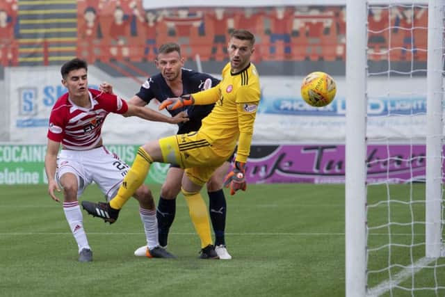 Dundee's Andy Boyle heads in the opener. Pic: SNS/Bill Murray