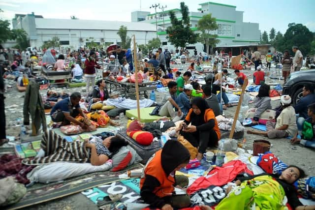 Medical team members help patients outside a hospital after an earthquake and a tsunami hit Palu, on Sulawesi island on September 29. Picture: AFP/Getty Images