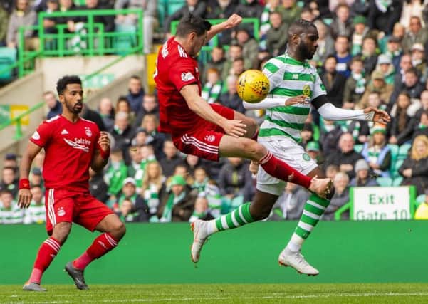 Aberdeen's Scott McKenna challenges Odsonne Edouard, leaving the Celtic player injured. Picture: SNS