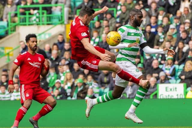 Aberdeen's Scott McKenna challenges Odsonne Edouard, leaving the Celtic player injured. Picture: SNS