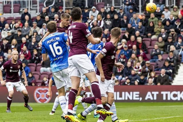 Jimmy Dunne heads home Hearts second goal to all but seal the victory. Picture: SNS.