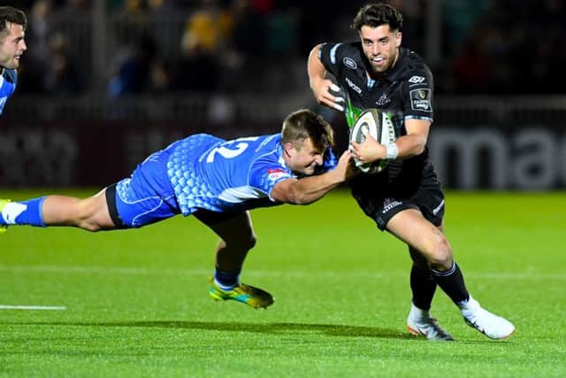 Adam Hastings evades the challenge of Dragons Jarryd Sage. Picture: SNS/SRU