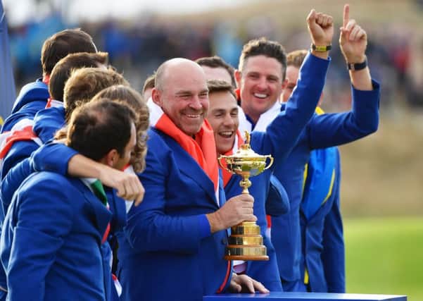 Surrounded by his triumphant European team, captain Thomas Bjorn shows off the Ryder Cup. Picture: Stuart Franklin/Getty Images