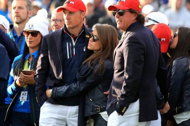 Jordan Spieth, left, and Phil Mickelson try to take in the defeat. Picture: PA.