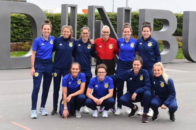 Members of the Scotland women's team pose for the cameras after qualifying for the 2019 World Cup. Picture: SNS