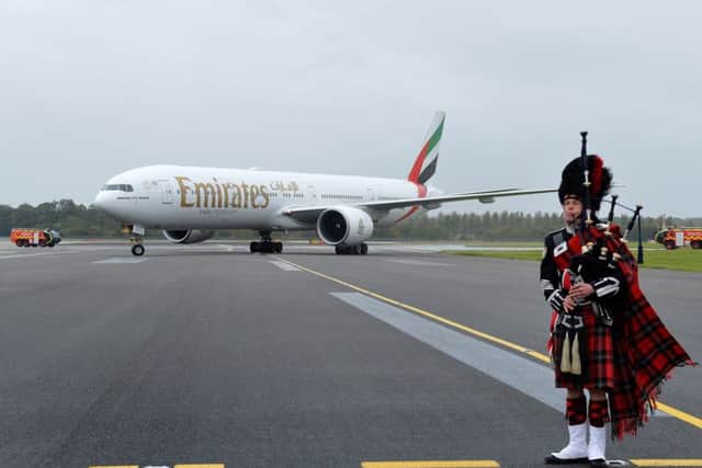 An Emirates Boeing 777-300ER is met by a piper at Edinburgh Airport. Picture: PA