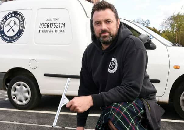Thomas Smart is turning heads hundreds of miles south of the border - by wearing his kilt when he climbs up and down ladders to work as a window cleaner. Picture: SWNS.
