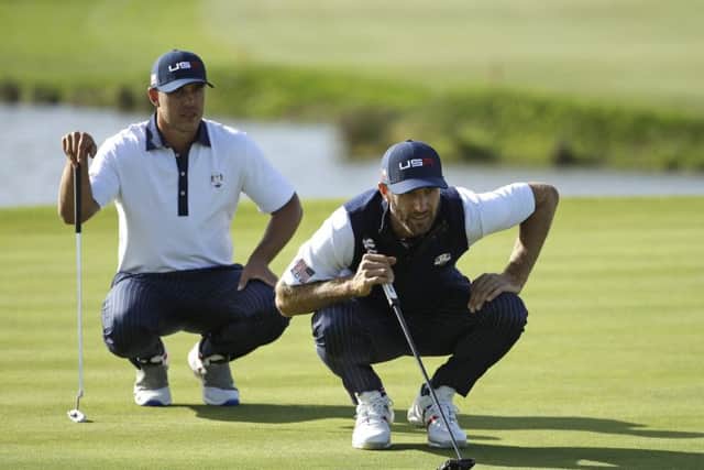Dustin Johnson, right, and Brooks Koepka line up a putt during the foursomes at Le Golf National. Picture: Matt Dunham/AP