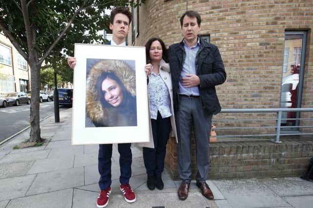 Nadim and Tanya Ednan-Laperouse, with their son Alex, holding a picture of Natasha outside West London Coroners Court, following the conclusion of the inquest. Picture: Jonathan Brady/PA Wire