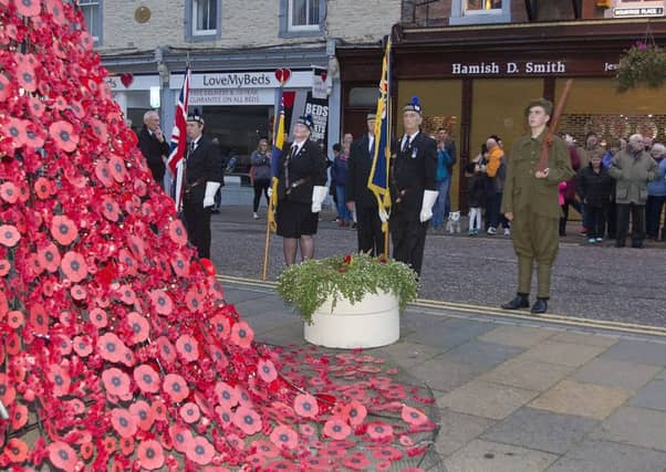 Standard bearers, under the command of Brian McLeod, stand to attention at the 1514 memorial.