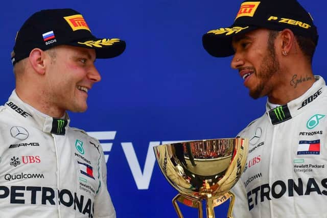 Valtteri Bottas, left, with winner and team-mate Lewis Hamilton on the Russian GP podium. Picture: Andrej Isakovic/AFP/Getty