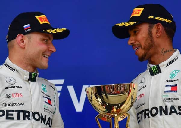 Valtteri Bottas, left, with winner and team-mate Lewis Hamilton on the Russian GP podium. Picture: Andrej Isakovic/AFP/Getty