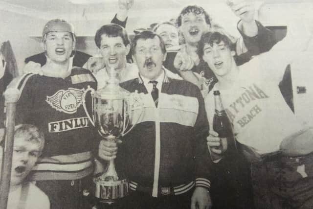 Fife Flyers 1985, John Haig, team manager holding the British championship trophy in the dressing-room with players Gordon Goodsir, Jimmy Pennycook, Brian Peat, Gordon Latto, Neil Abel and Gary McEwan.
