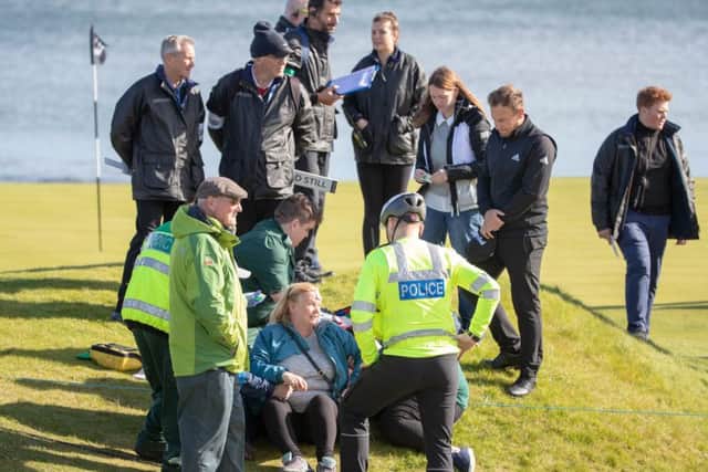 Tyrell Hatton and Kingsbarns course officials with the spectator hit by his tee shot at the15th. Picture: Kenny Smith/PA Wire