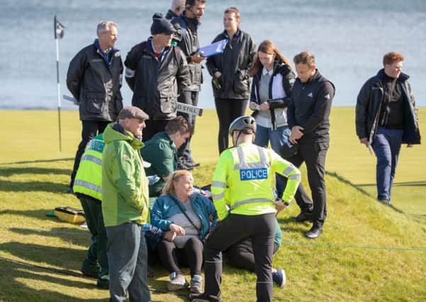 Tyrell Hatton and Kingsbarns course officials with the spectator hit by his tee shot at the15th. Picture: Kenny Smith/PA Wire