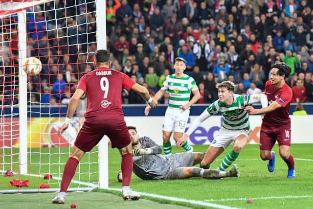 Takumi Minamino, right, nets Salzburg's second on the night. Picture: AFP/Getty