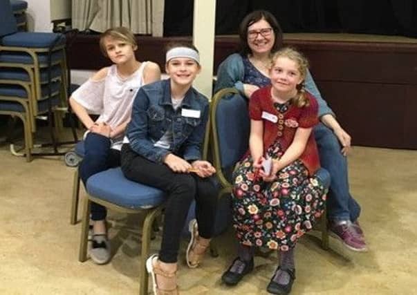 A group of young Quakers at the foot of a peace pole to be sited at the Helix on Sunday, with a message which reads: 'May peace prevail on earth'.